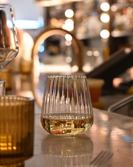 Close-up of a fluted glass tumbler with liquid, from Luigi Bormioli Optica.