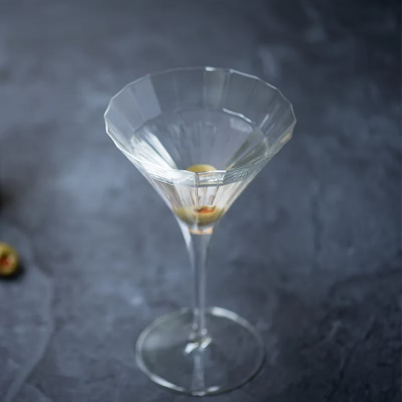Elegant Bach martini glass with faceted bowl, filled with a classic martini.
