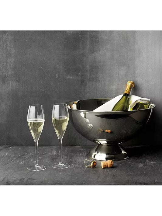 Luigi Bormioli champagne glasses next to a chilled wine bottle