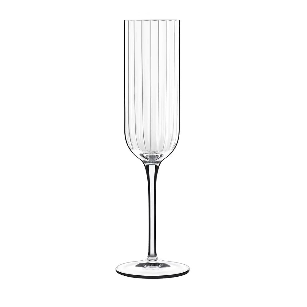 Elegant flute for sparkling wine with slender stem and vertical ridges.