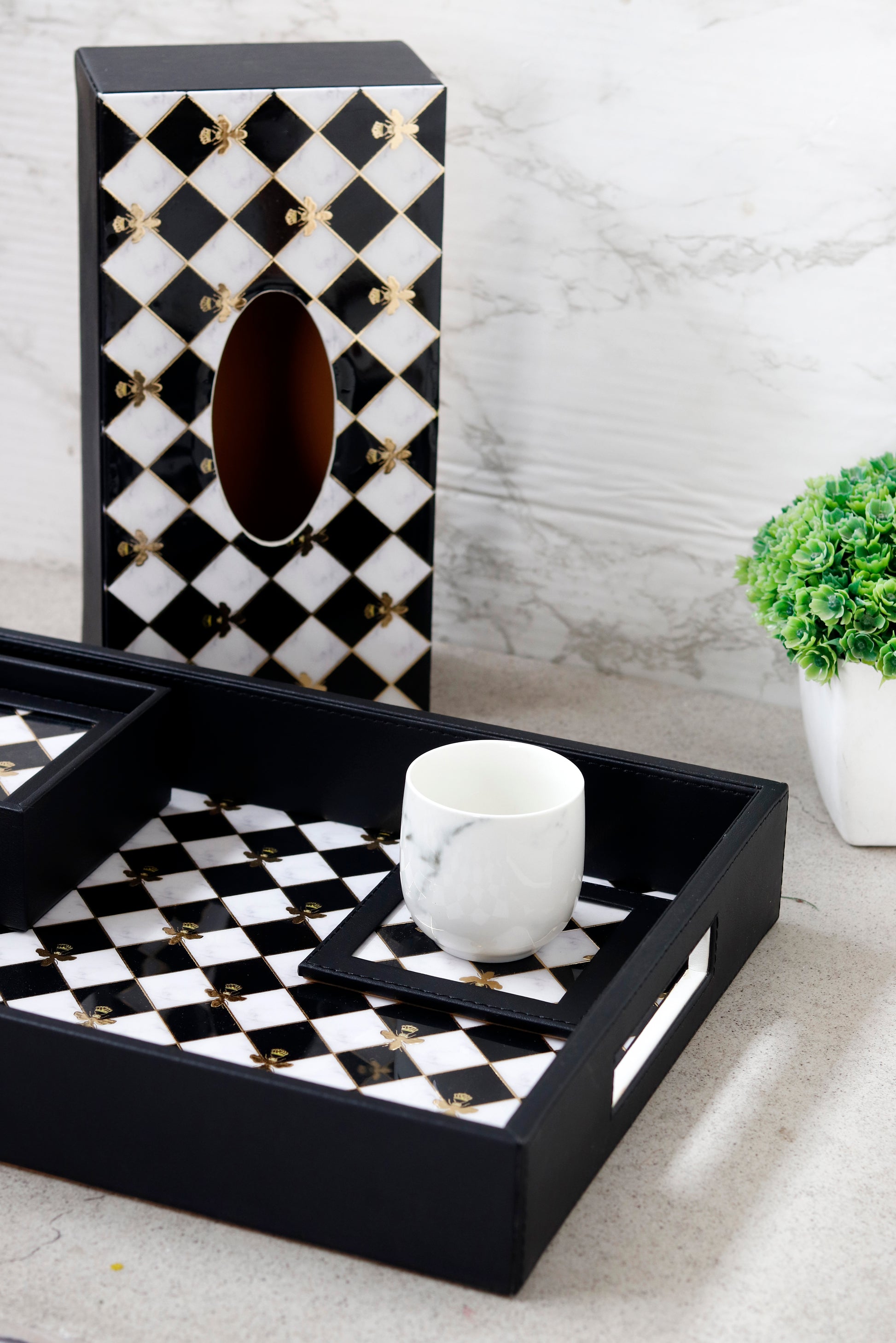 Tissue holder with bumblebee pattern in black and white.