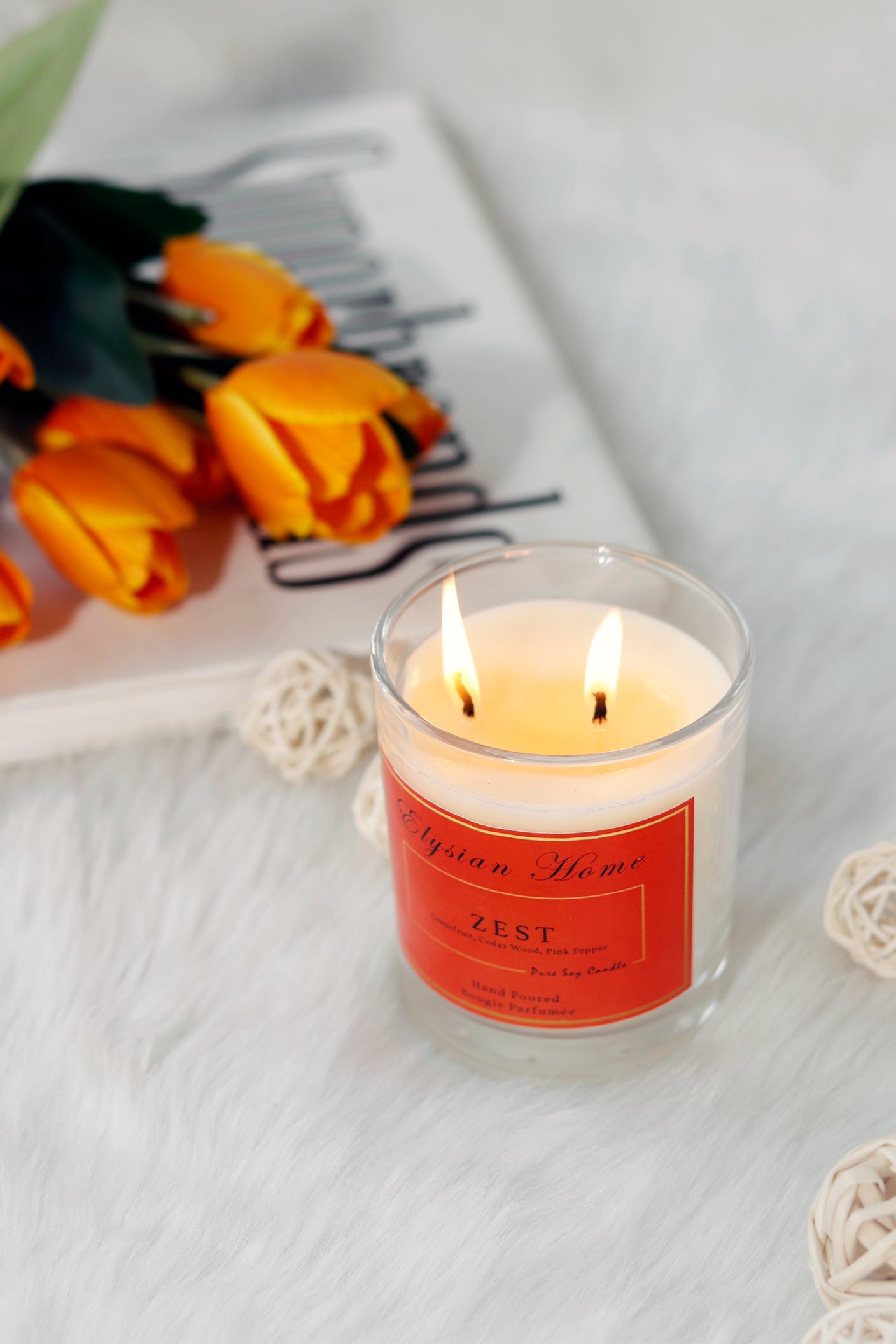 Burning Hermes Zest candle with grapefruit and cedar wood scent.
