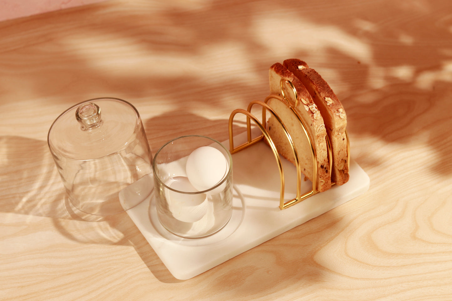 Breakfast tray with toast rack, eggs and domed glass.