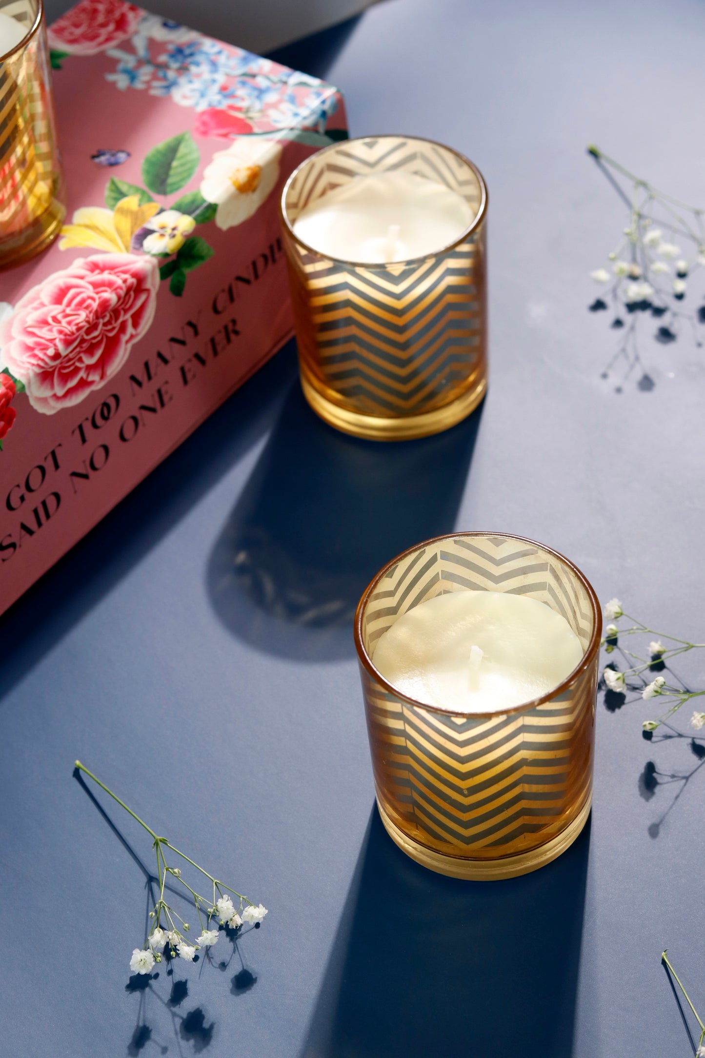 Mehnaaz candle set with gold zigzag design and floral book.