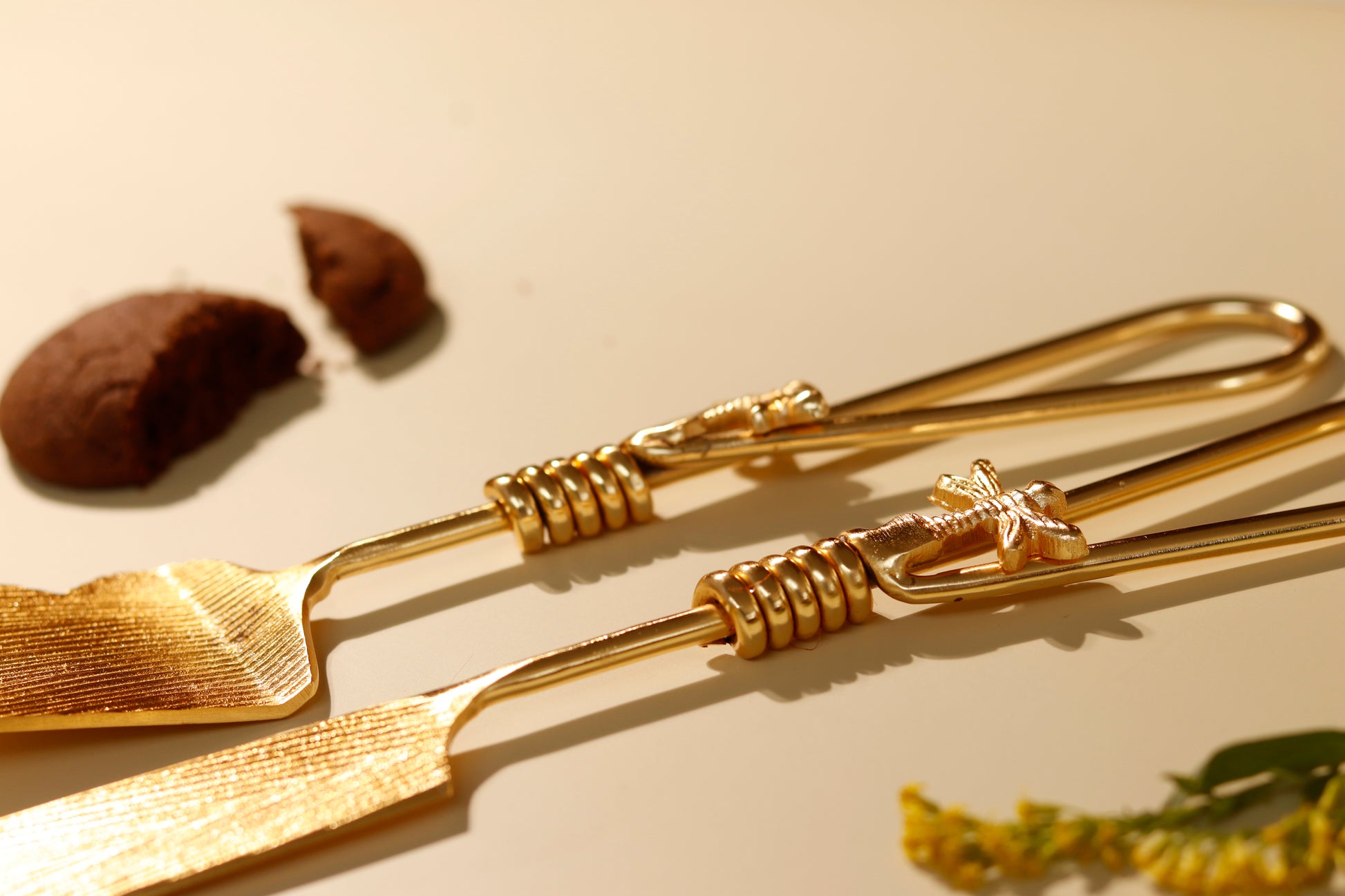 Elegant gold firefly cake server and knife set with insect details.