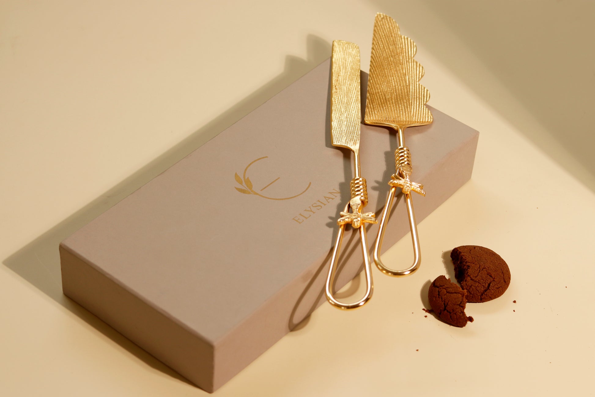 Elegant golden knife and cake server set with firefly details.