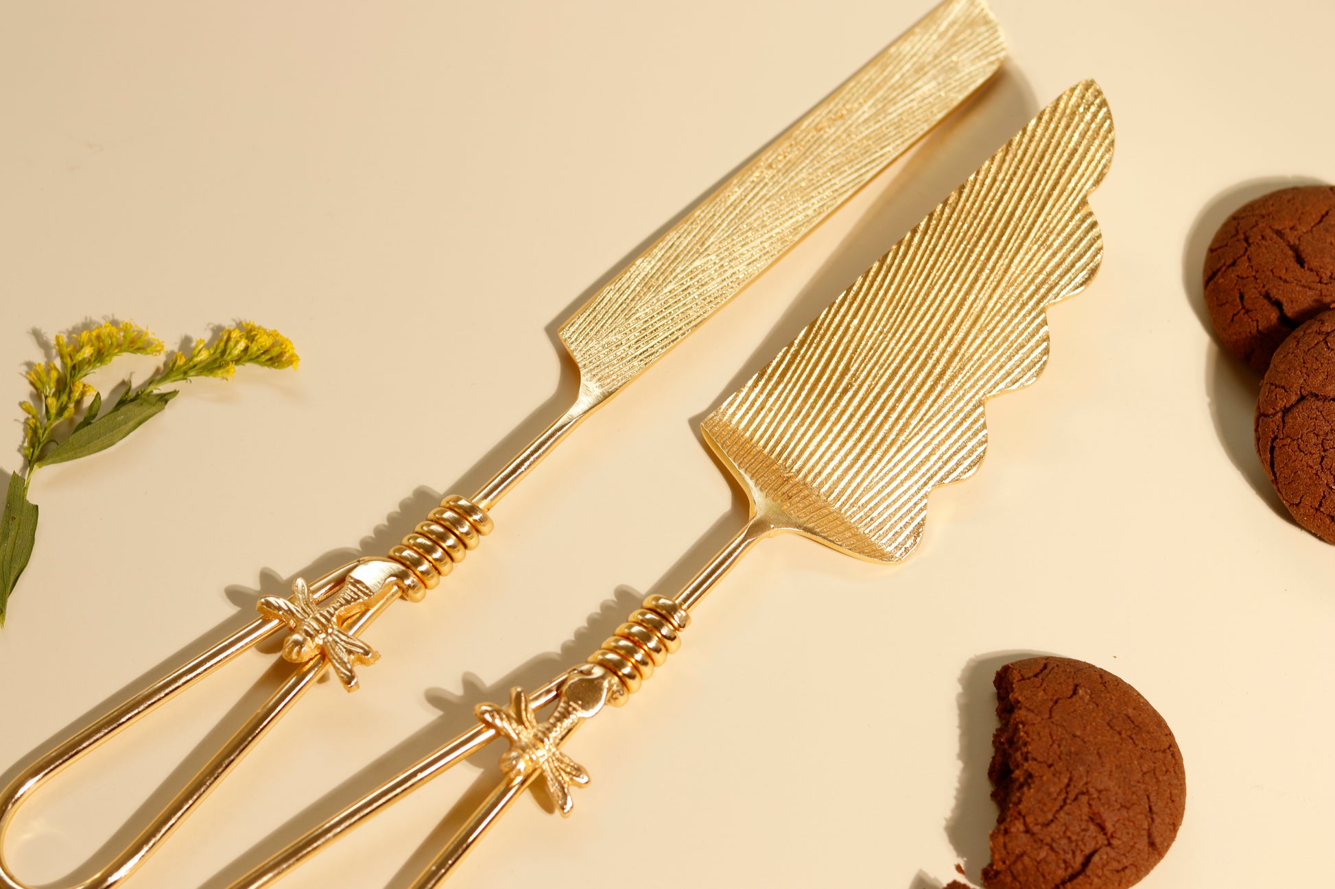 Golden cake knife and server set with firefly details.