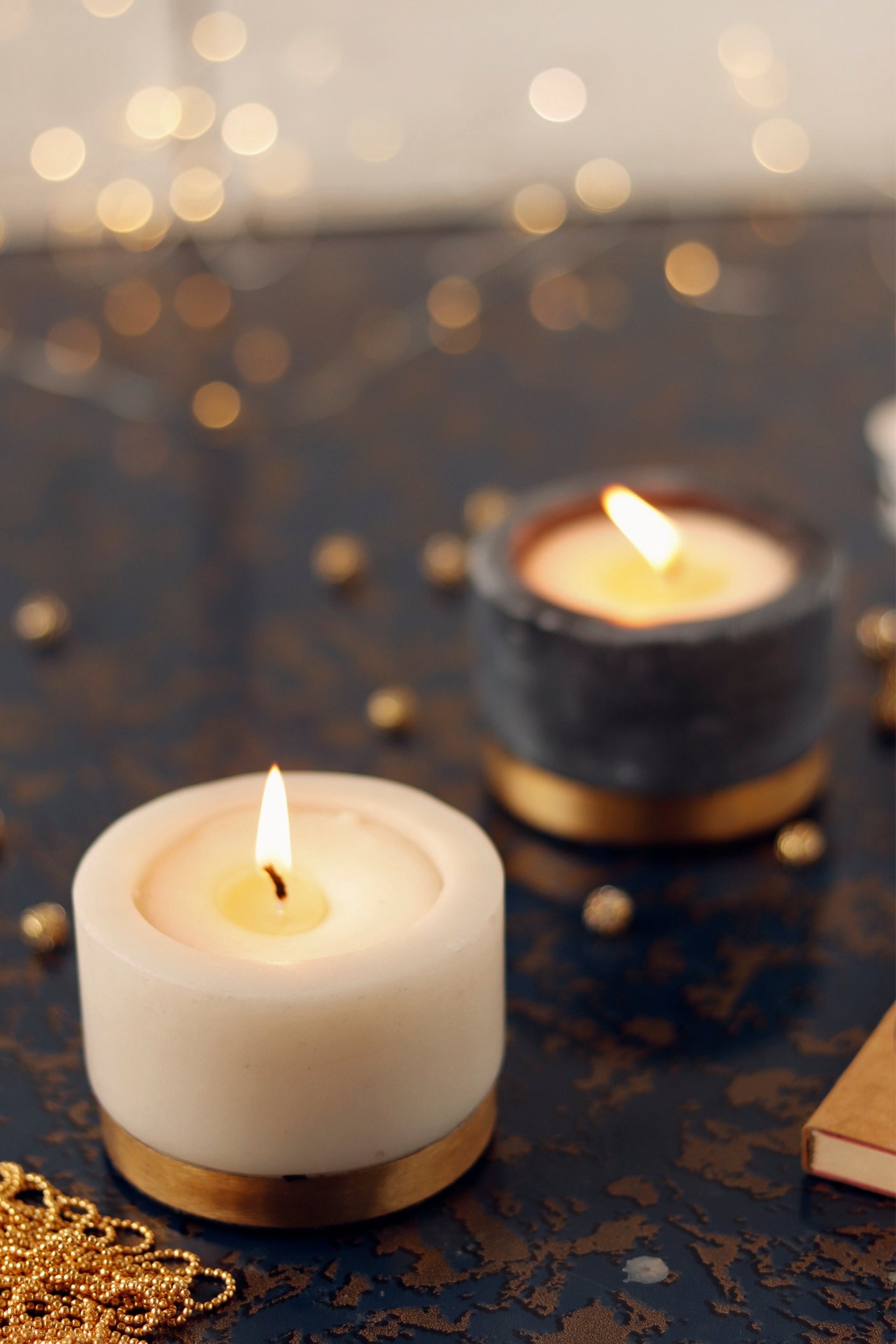 Lit marble candles with gold base accent