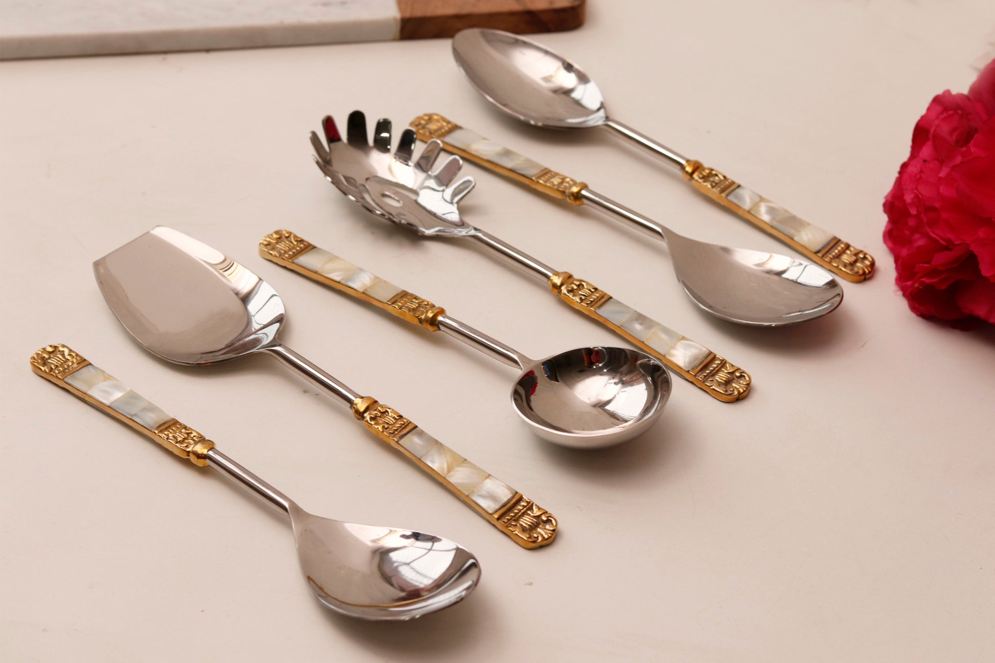 Serving spoon set with mother of pearl and gold inlay handles.