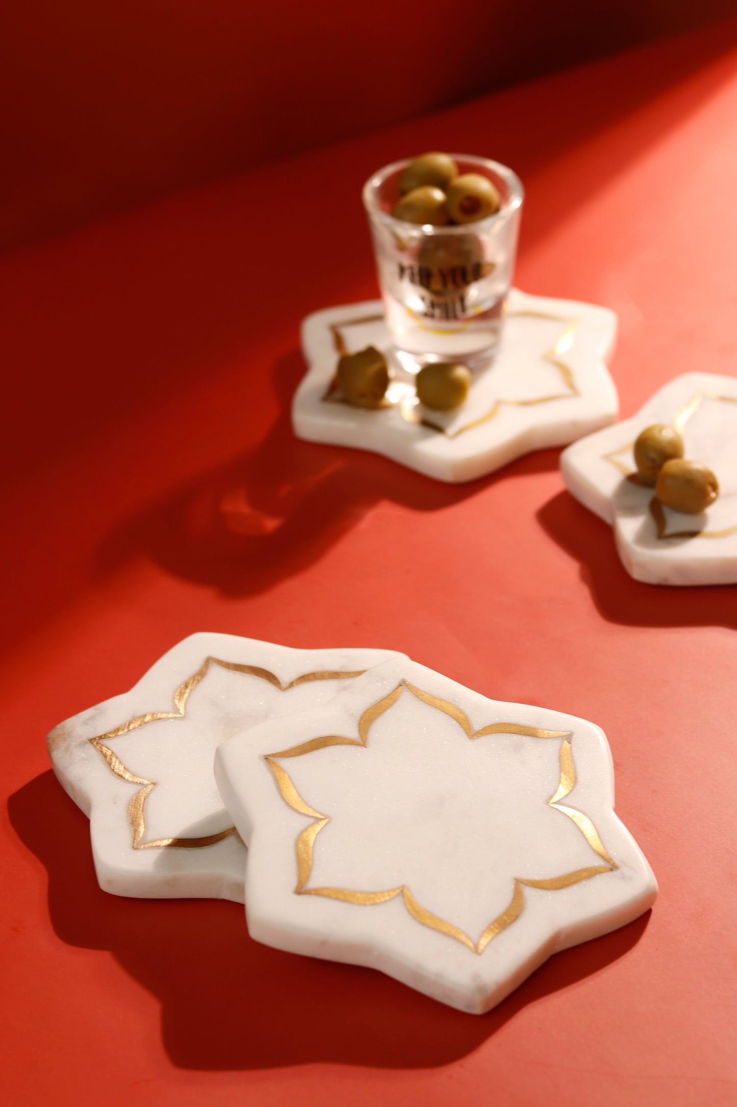 Marble lotus coasters with brass inlay design.