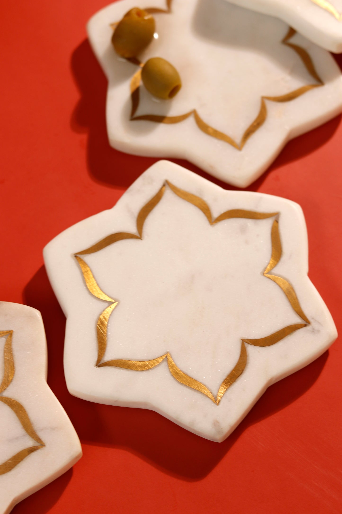 Marble coasters with brass inlay in a lotus design.