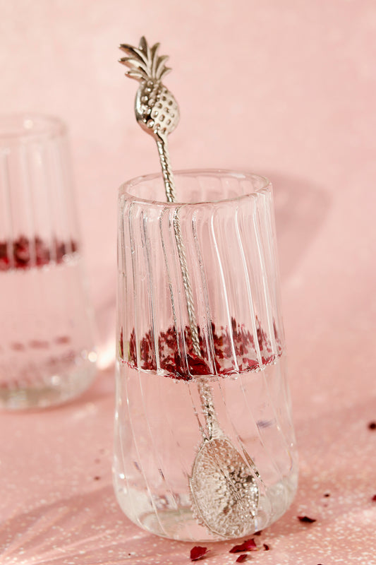 Brass stirrer with pineapple handle in ribbed glass.