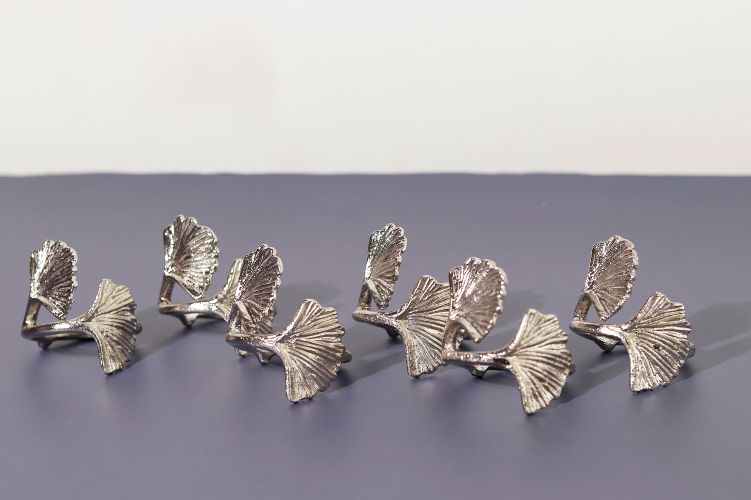 Set of six silver Elm napkin rings with leaf design.