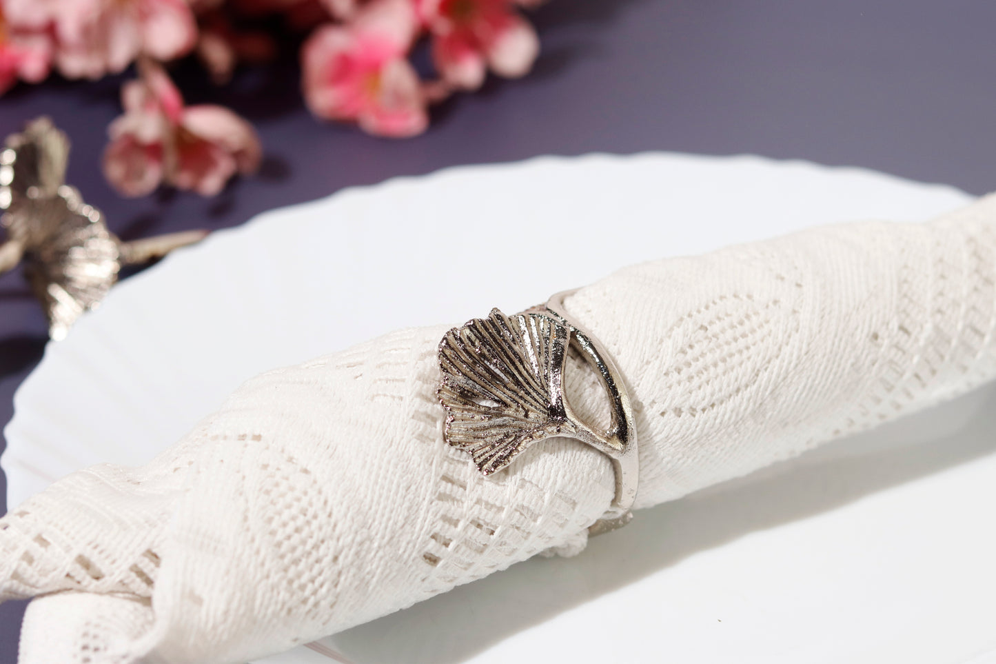 Elm leaf napkin ring on white lace napkin.