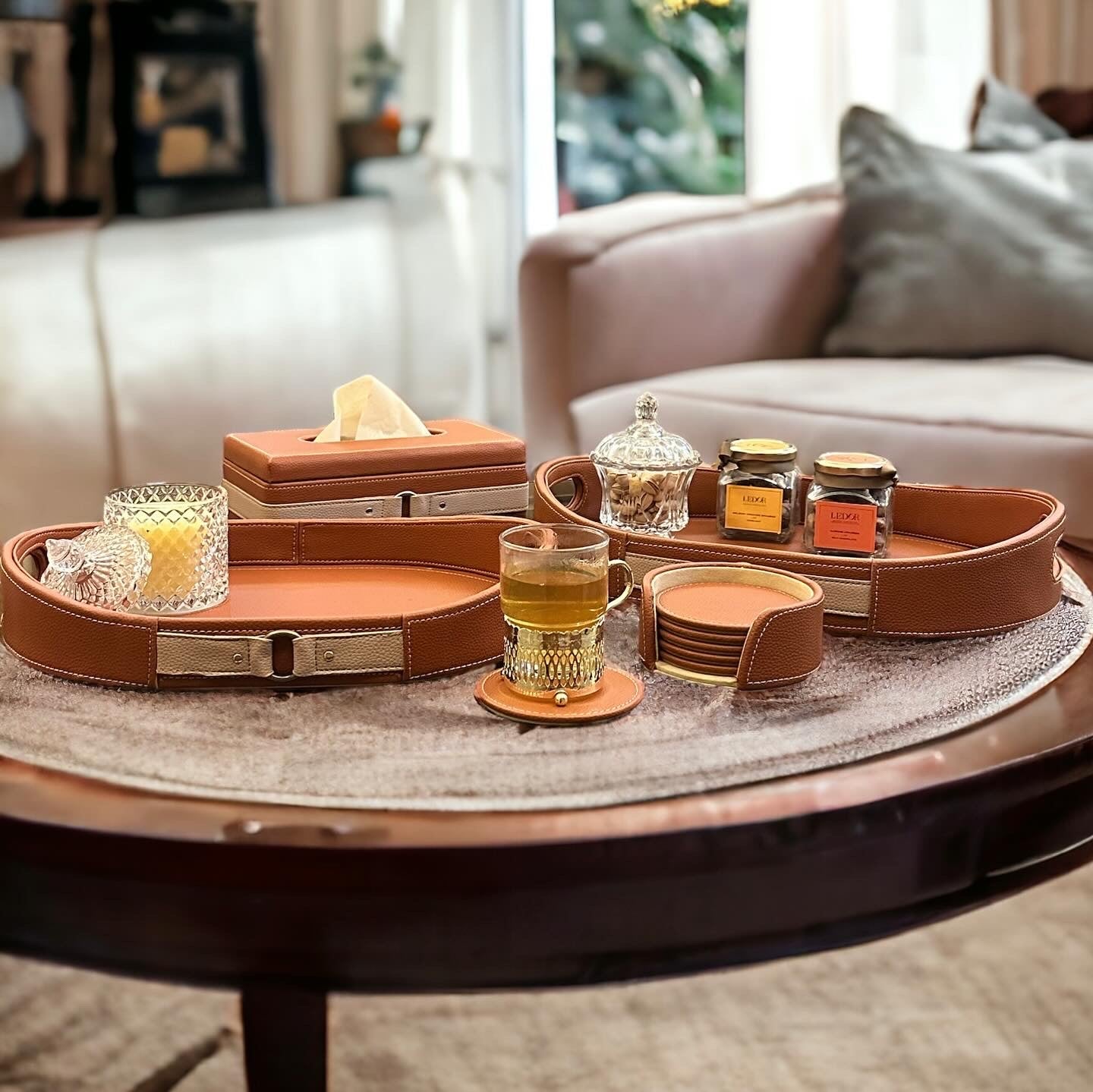 Cognac leather tray with candle and snacks.