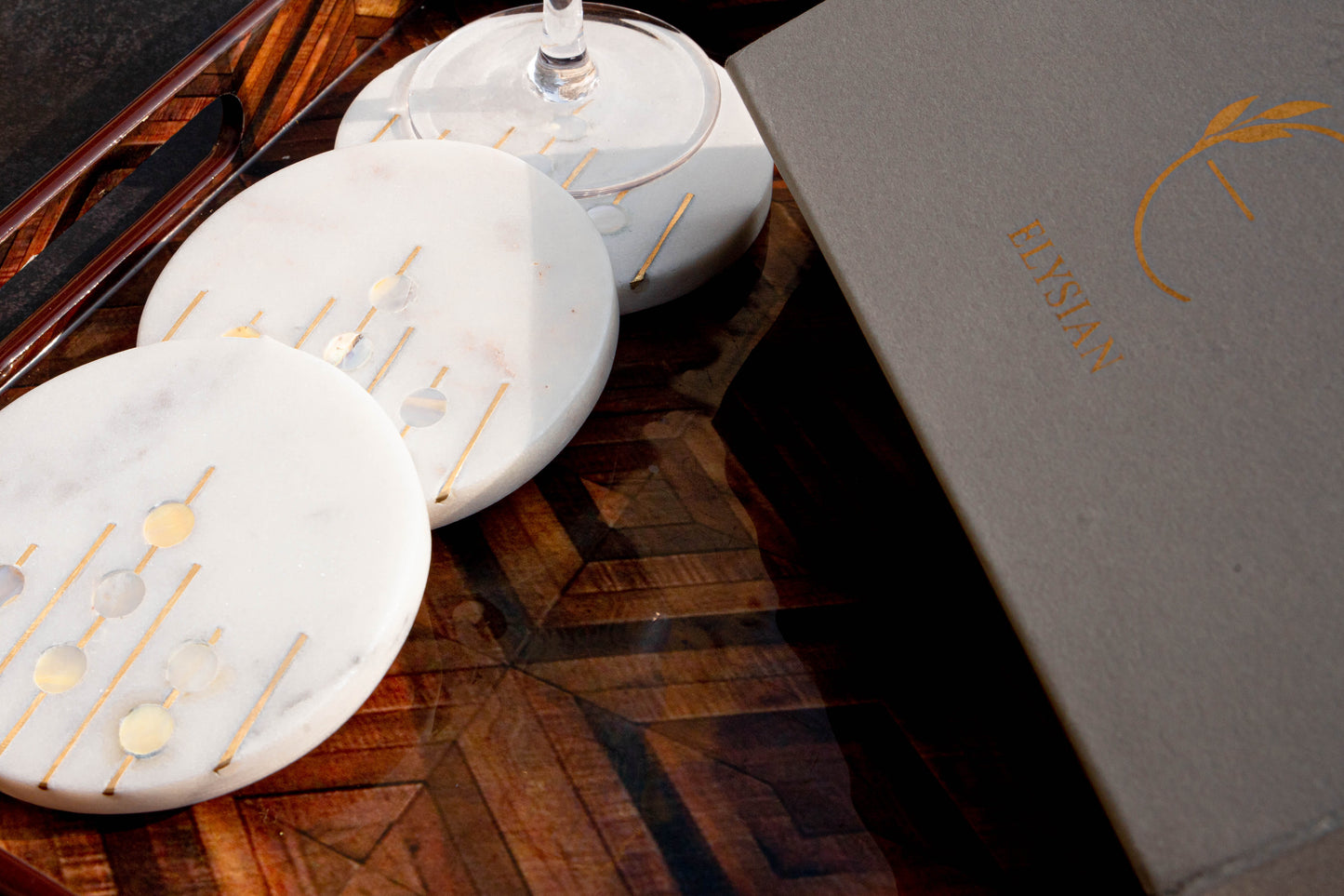 Mother of pearl coasters with brass inlay, set of four.