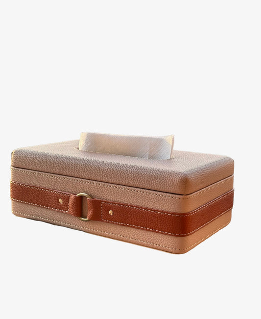Beige leather tissue box with brown strap and metal buckle.