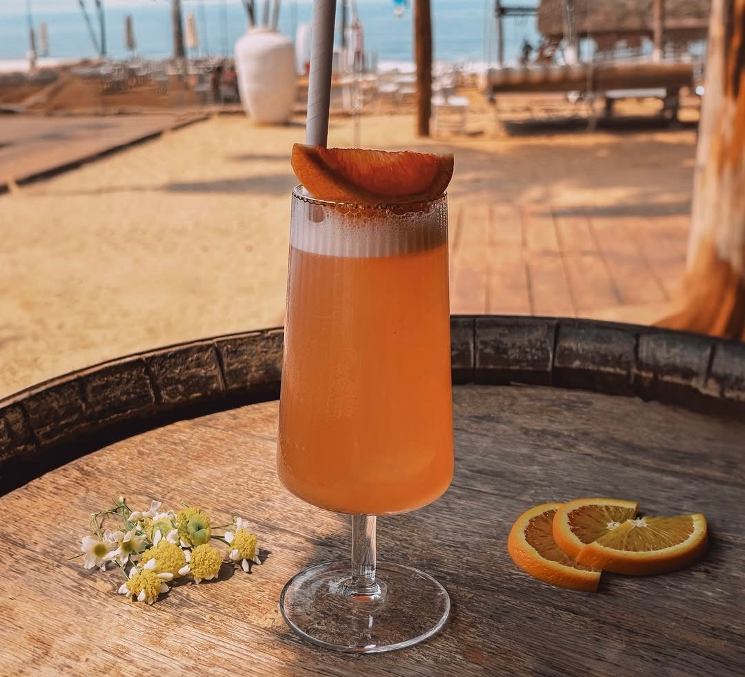 Fitzgerald beer glass with cocktail and orange slice garnish.