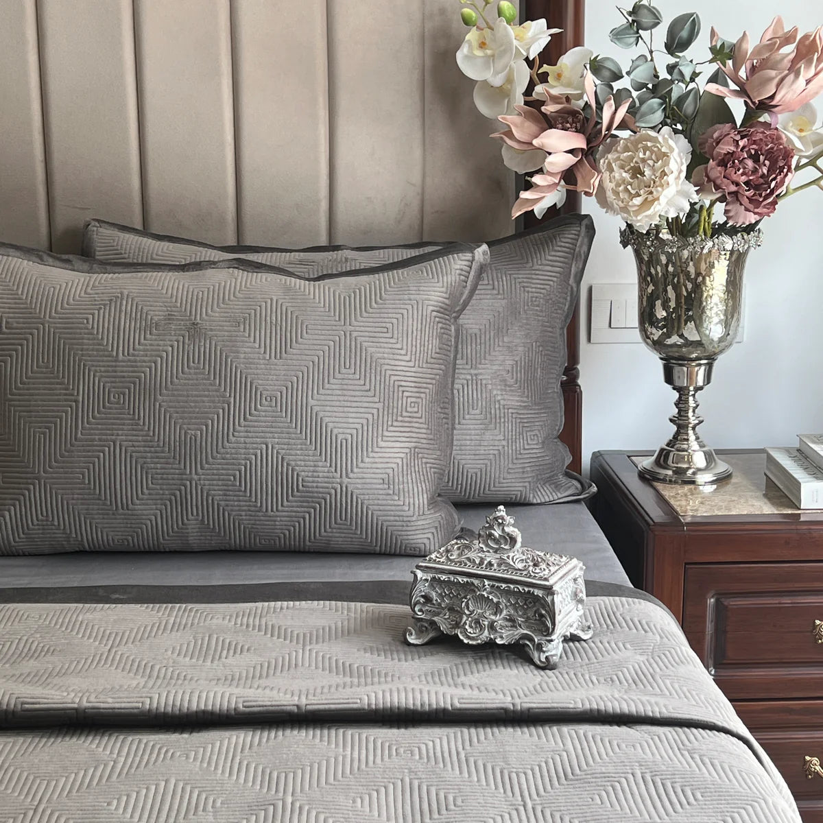Dark grey velvet bedspread featuring a maze pattern design.