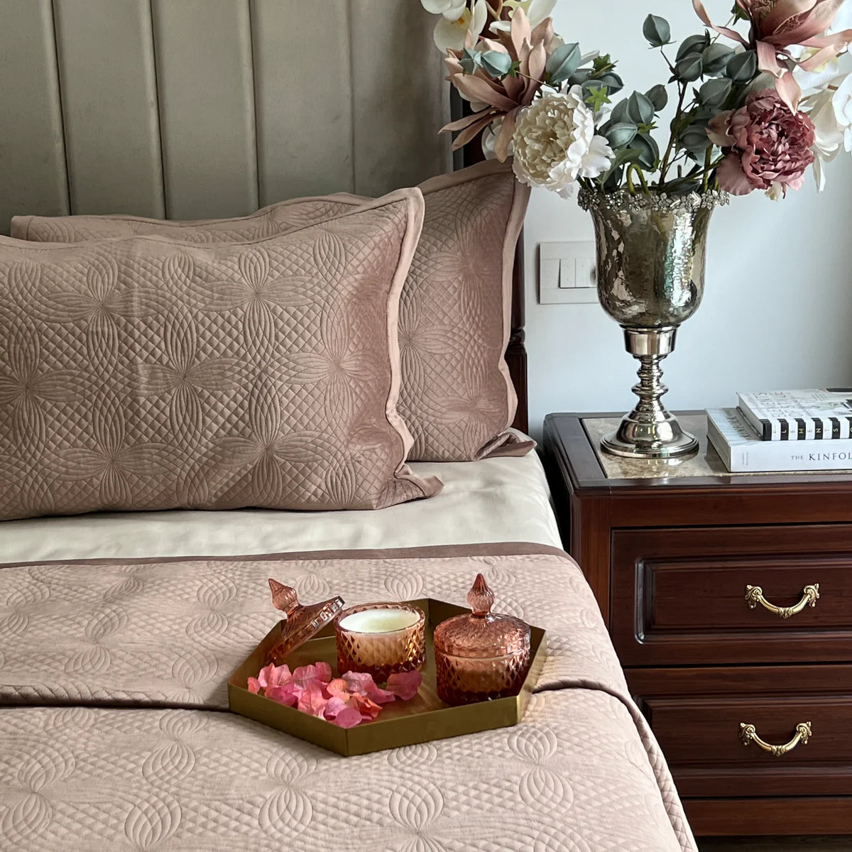 Buff velvet bedspread with quilted pattern and matching pillow covers.