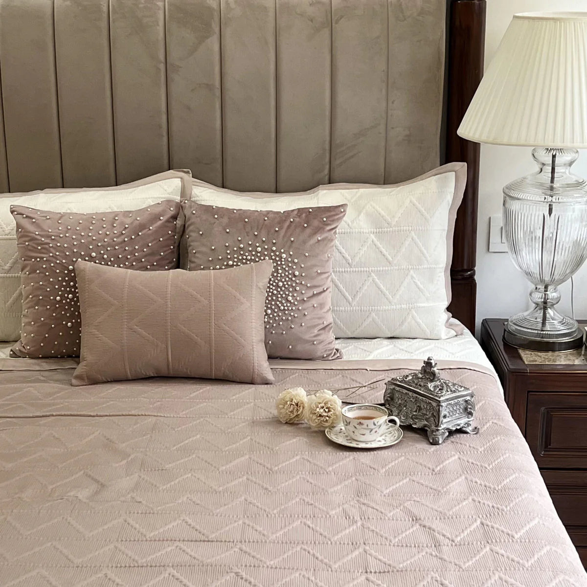 Buff & ivory trigon reversible cotton bedspread on a neatly made bed.