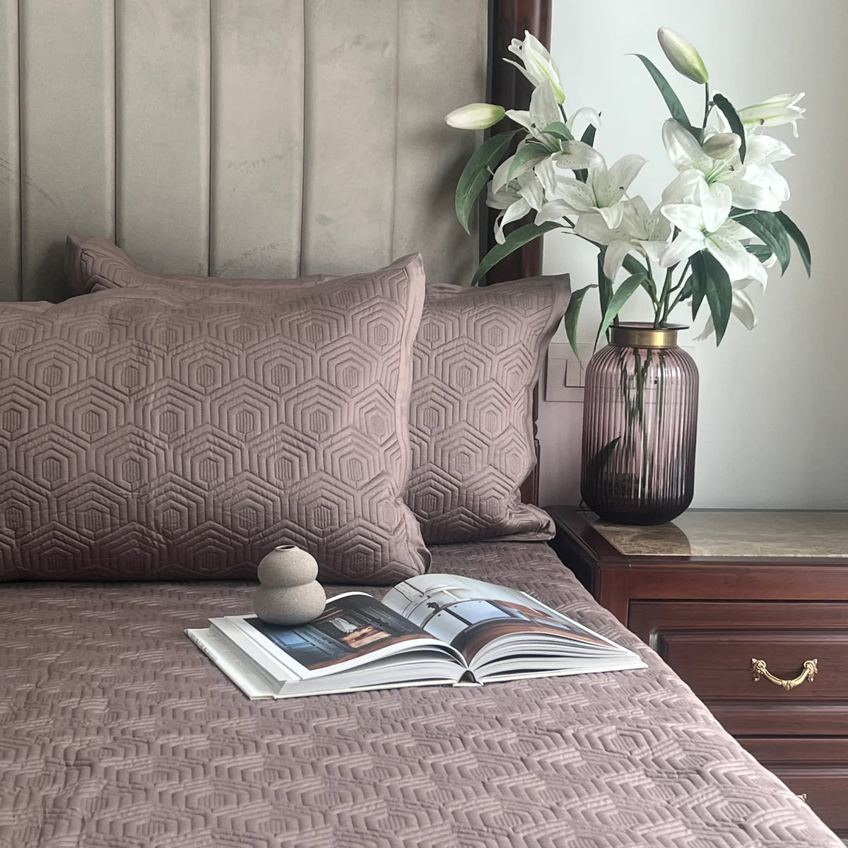 Taupe cotton bedspread with geometric pattern and matching pillow shams.