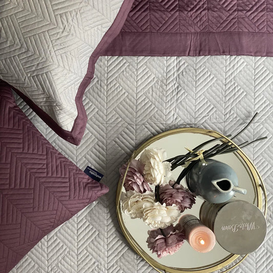 Sandstone grey and mauve reversible bedspread with a vector pattern.