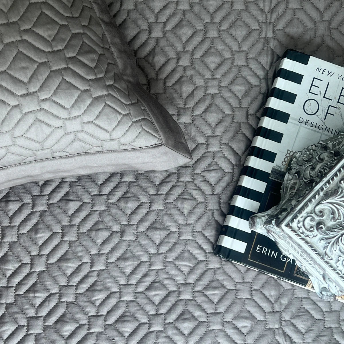 Olive grey cotton bedspread with geometric quilt pattern and matching pillow.