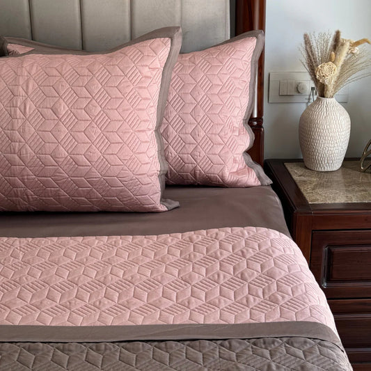 Rose taupe reversible bedspread with quilted pattern.