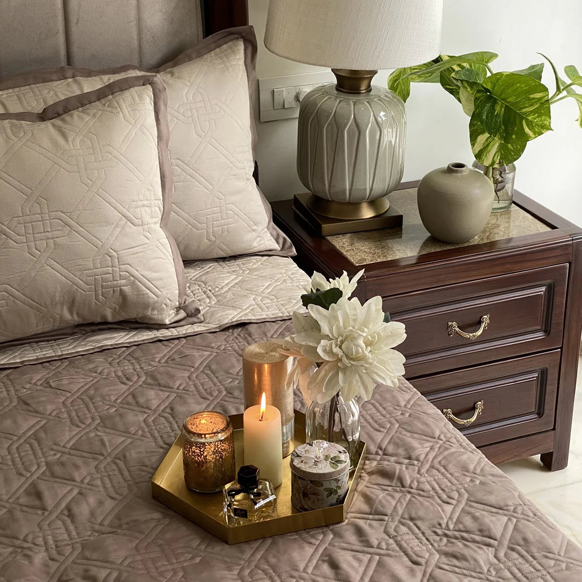 Beige taupe quilted reversible bedspread on a styled bed.