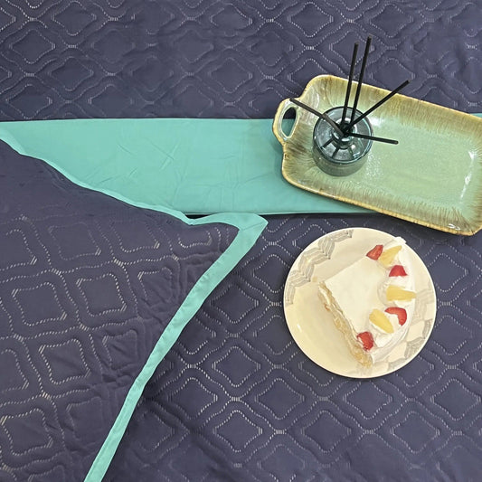Navy turquoise quilted bedspread.