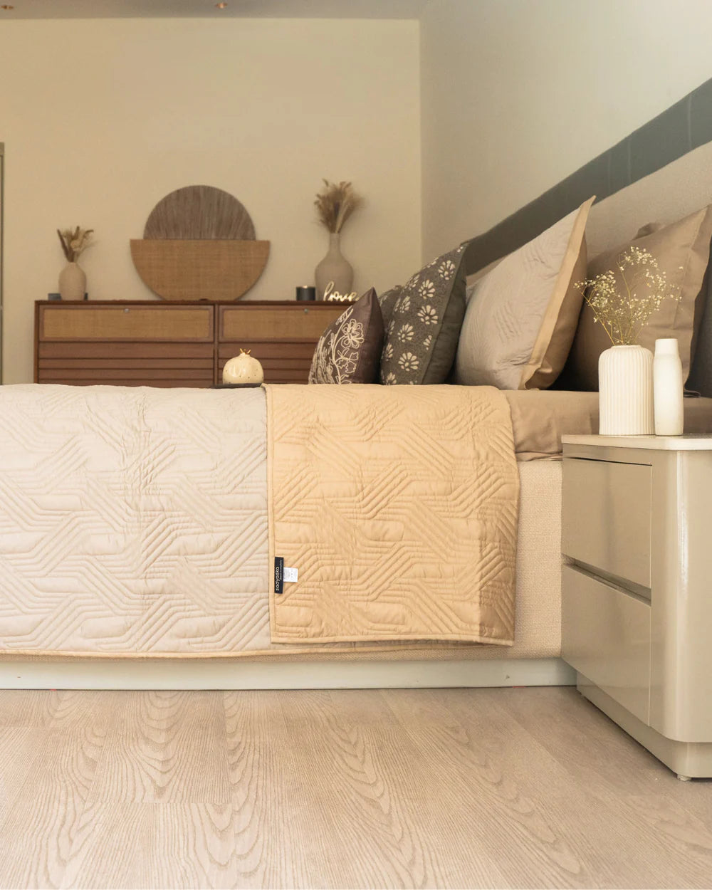 Reversible sand beige magnolia quilted bedspread with geometric pattern.