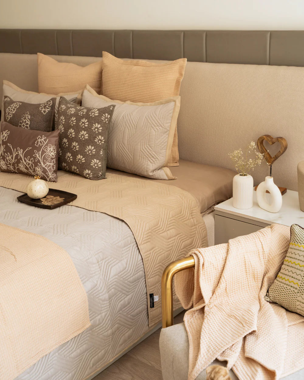 Sand beige magnolia reversible bedspread with quilted texture and geometric pattern.