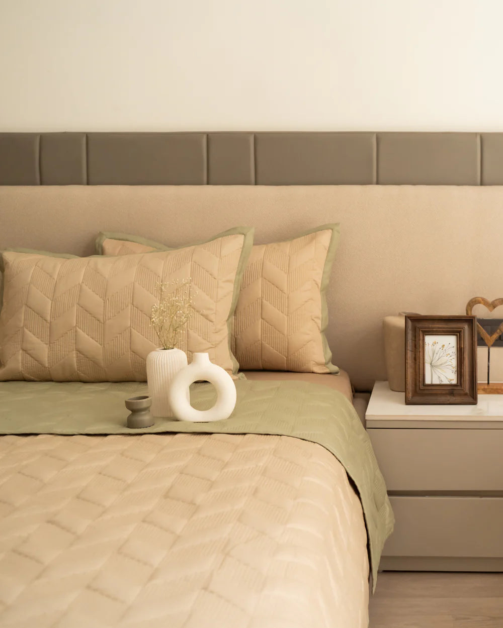 Sand and forest green quilted reversible bedspread with shams.