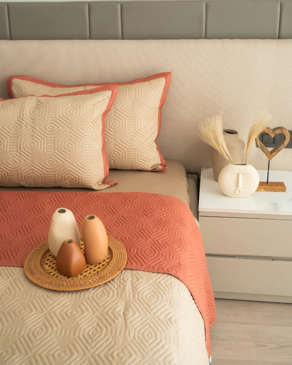 Sand and terracotta quilted bedspread with reversible design and matching pillows.