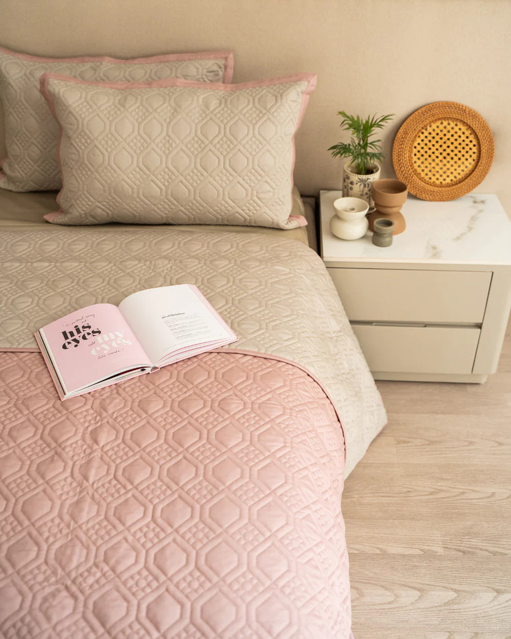 Quilted reversible bedspread in beige and old rose.