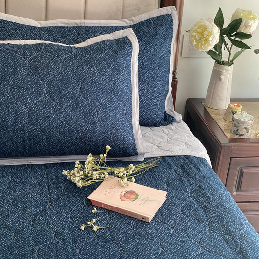 Indigo blue reversible bedspread with 100% cotton material and floral design.