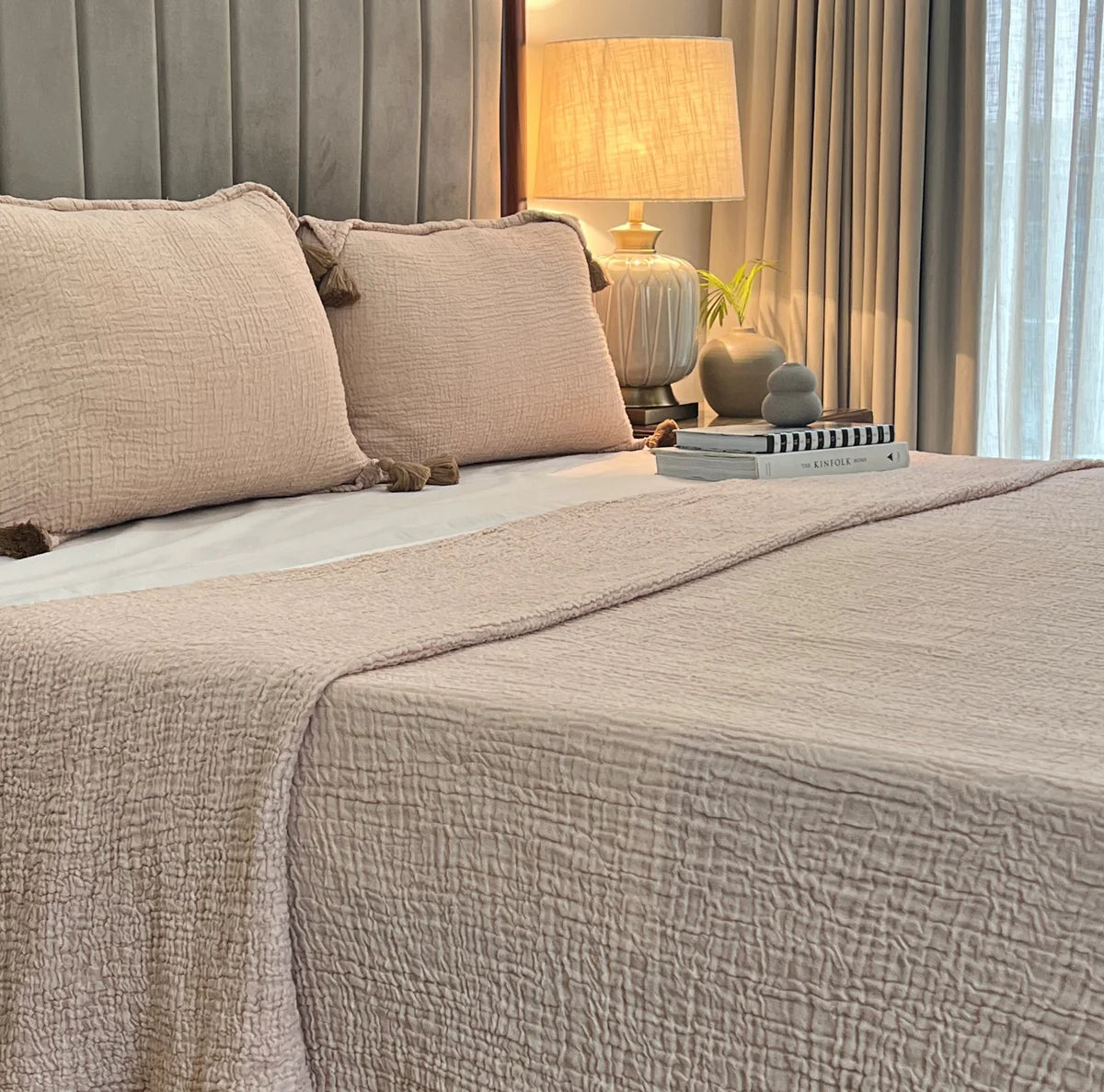 Sage woven bedspread with soft texture and matching pillow shams.