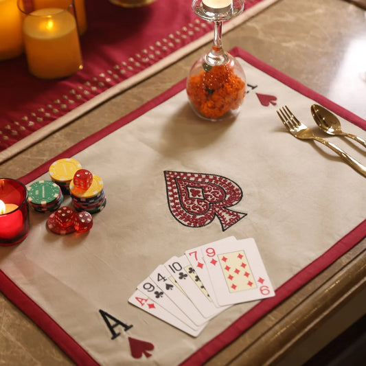 Deal & Dine placemat with spade embroidery and red border, part of table linen set.