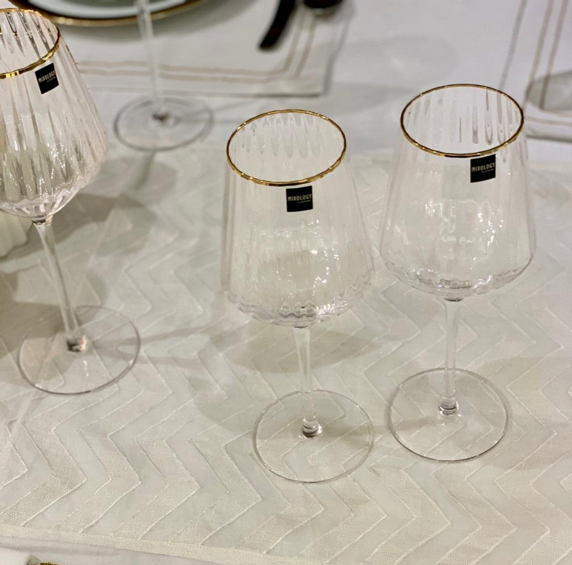Elegant gold rimmed wine glasses with textured clear glass.