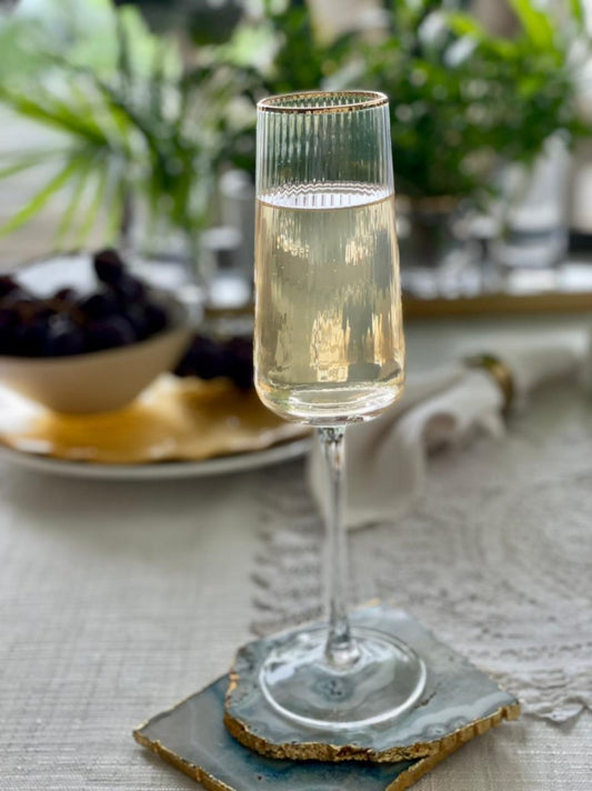 Elegant fluted cocktail glass with gold rim detail.
