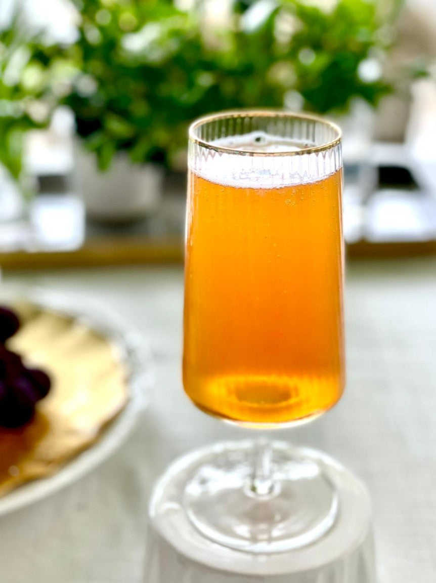 Stemmed beer glass with gold rim detail.