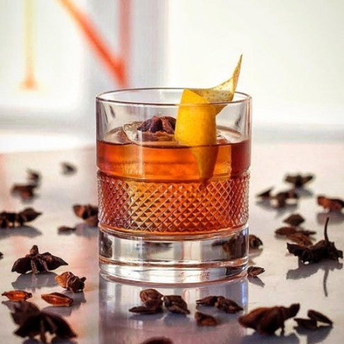 Brillante tumbler with cocktail, orange peel, and star anise.