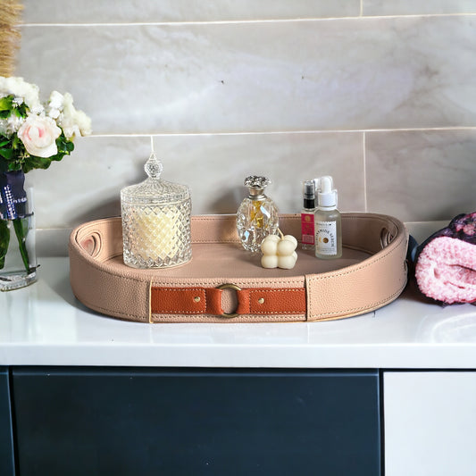 Beige leather tray with brown strap detail, great for organizing accessories.