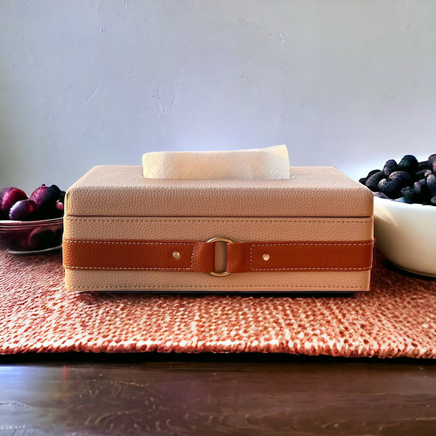 Beige leather tissue box with decorative brown strap and gold buckle.