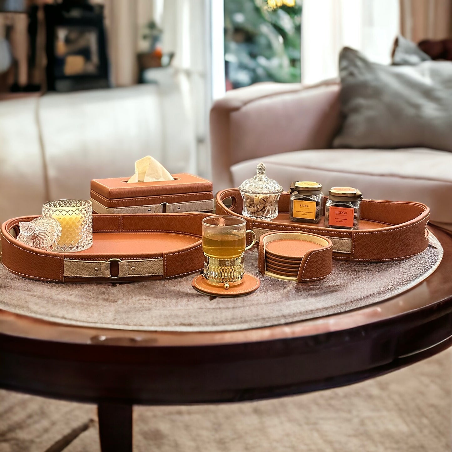 Cognac leather coasters and matching accessories on a table.