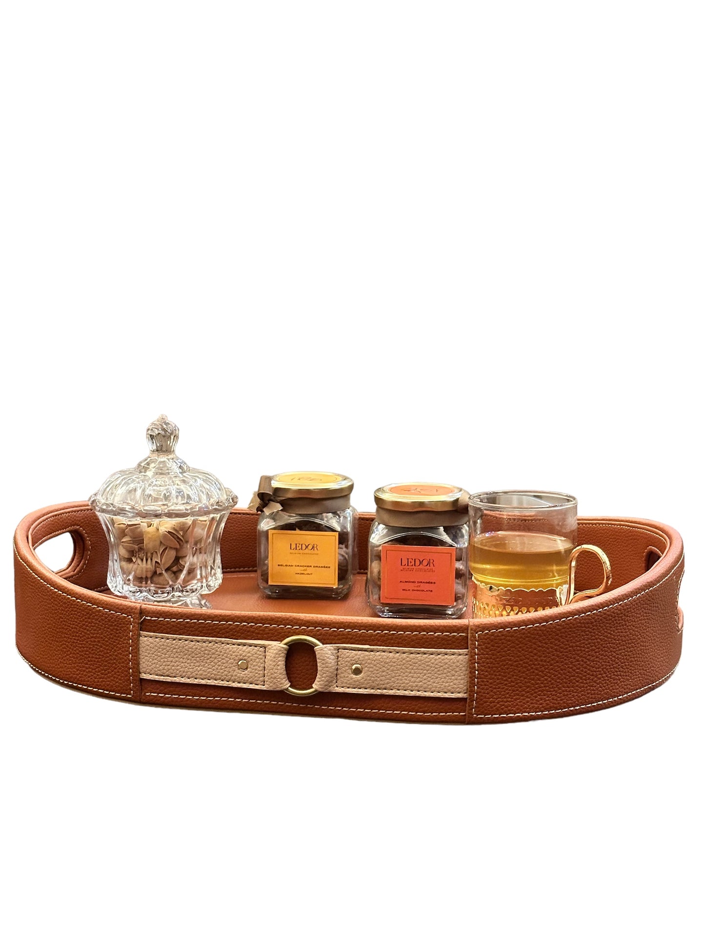 Cognac leather tray holds sweets and tea; luxury serving tray.