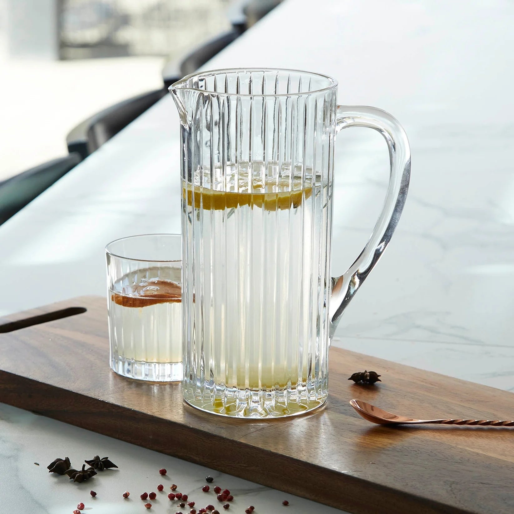 Crystal clear ribbed jug with handle, beverage service.