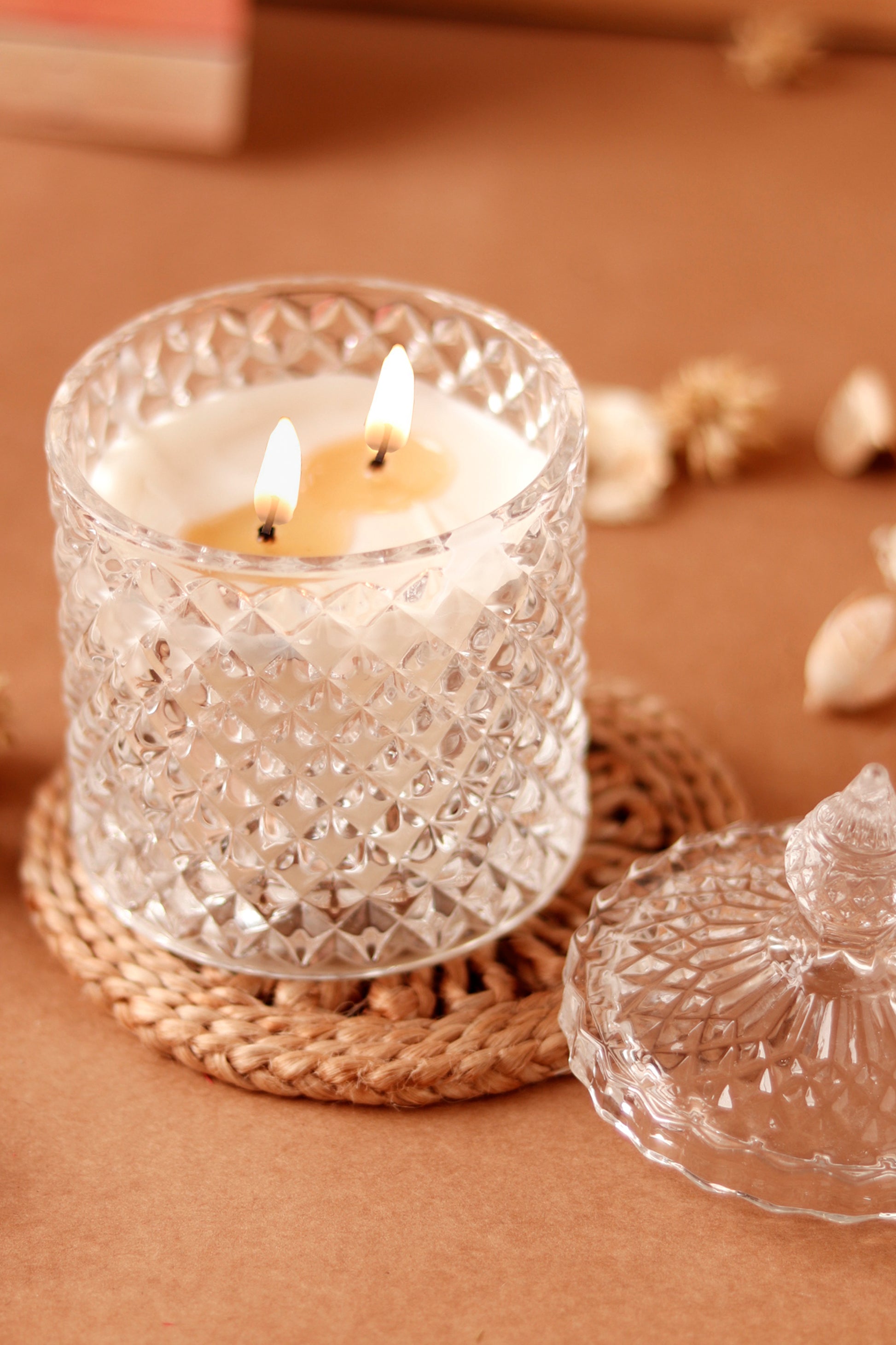 Burning Elysian crystal candle in decorative crystal jar with lid.