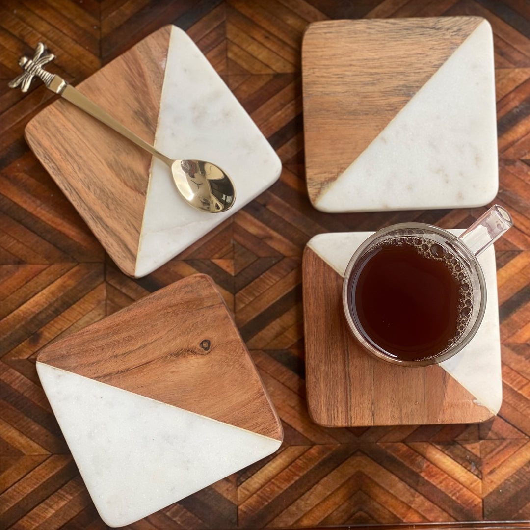 Set of four stylish marble and wood drink coasters.